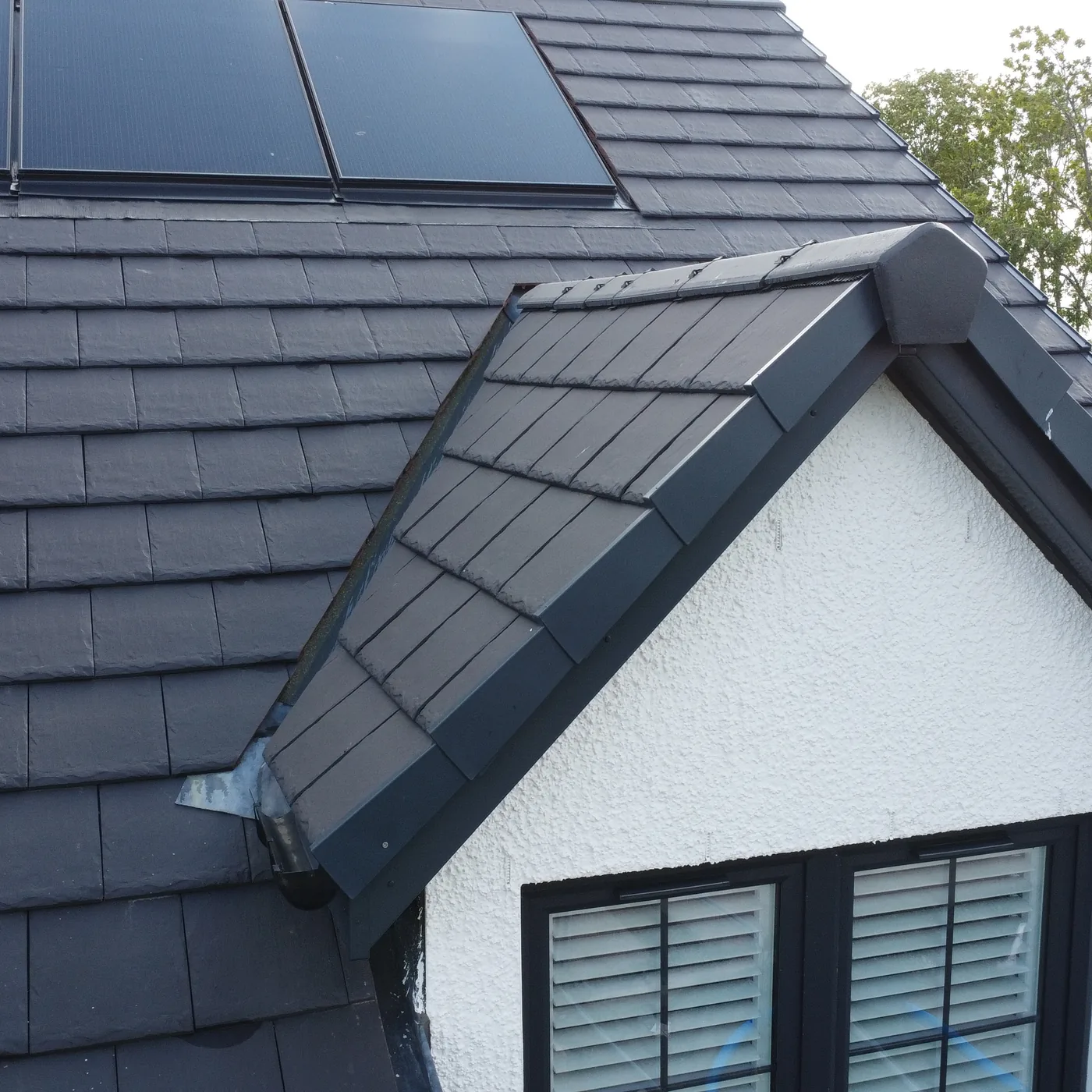 Close aerial view of roof tiles, ridge and flashing on a new build home